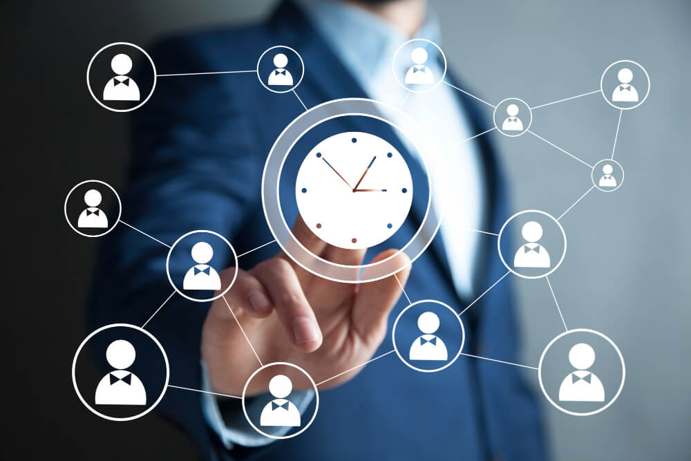 Businessman interacting with a digital interface for employee attendance software, showing connected employee icons and a central clock symbol.