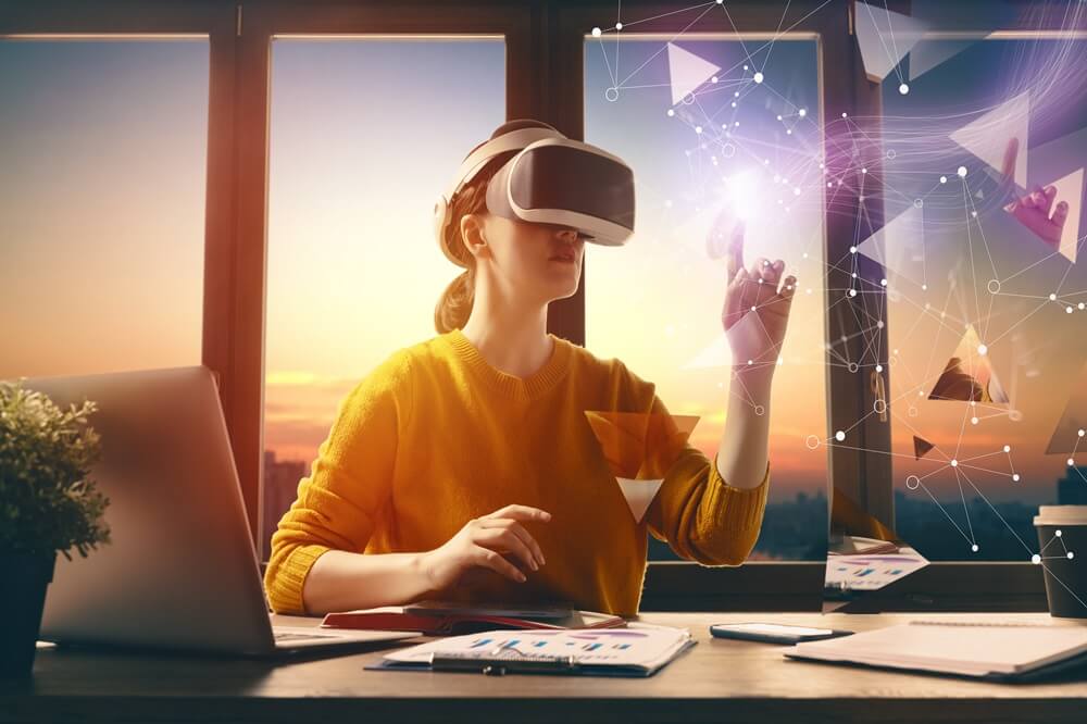 A woman wearing a VR headset interacts with a futuristic digital interface in a modern office setting during sunset, symbolizing the Future of HRMS and AI-driven workplace innovation.