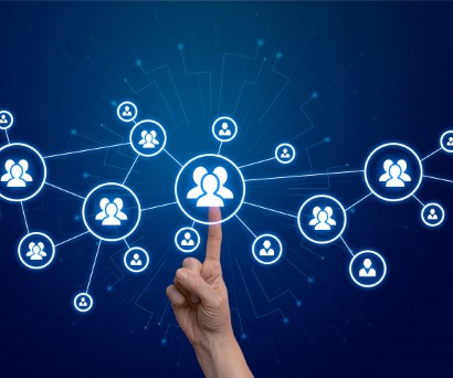 Hand selecting a team icon on a digital network interface representing HCM software in Pakistan for streamlined human capital management.
