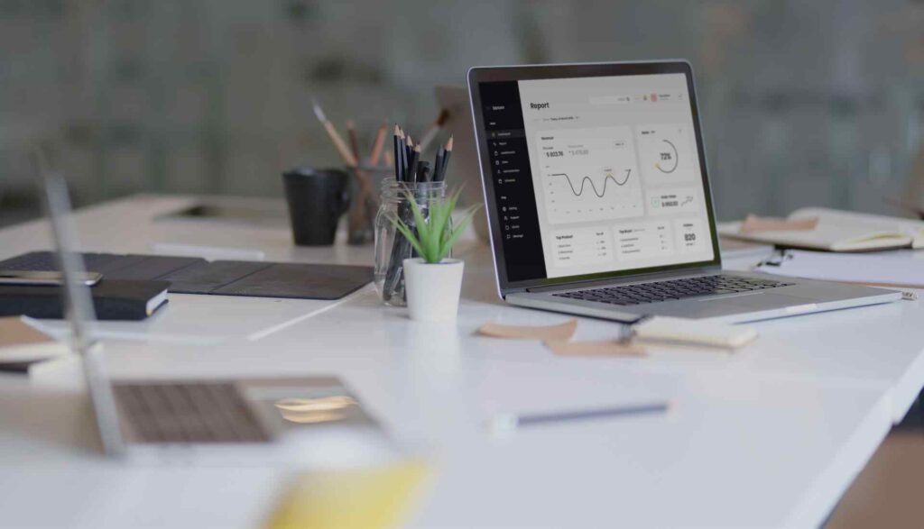 Payroll Software in Pakistan dashboard displayed on a laptop in a modern office setup, showcasing HR solutions Pakistan for business management.