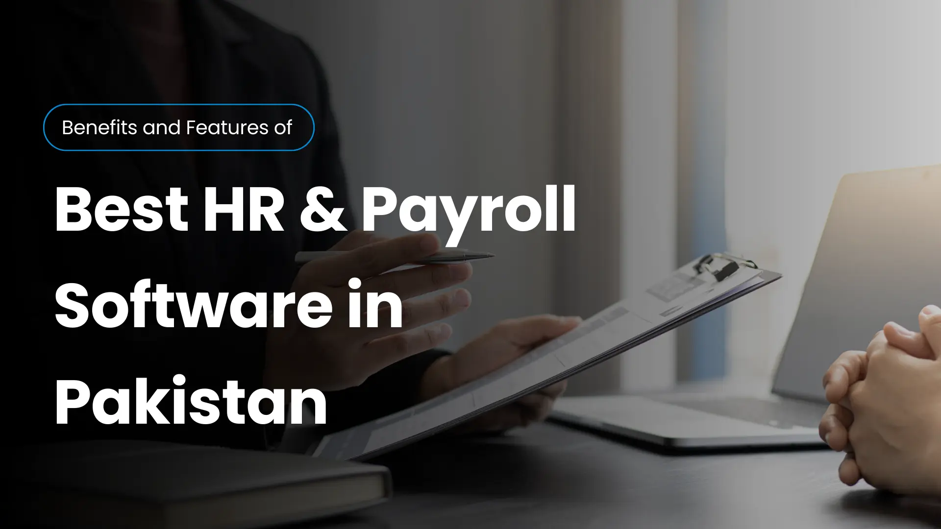 Business professionals discussing documents with a laptop on the desk, representing the benefits and features of the Best HR Payroll Software in Pakistan.