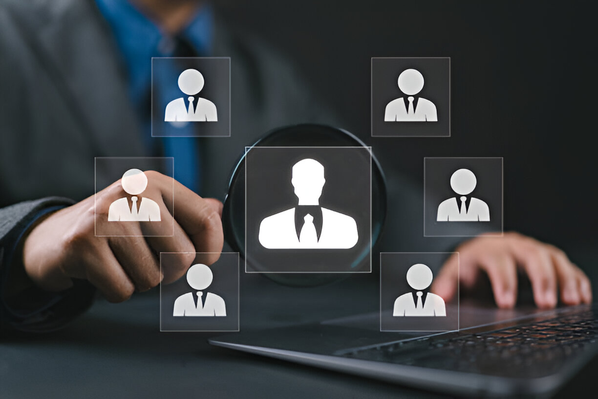 Business professional using Human Resource Management Information Systems (HRMIS) to analyze employee data on a digital interface.