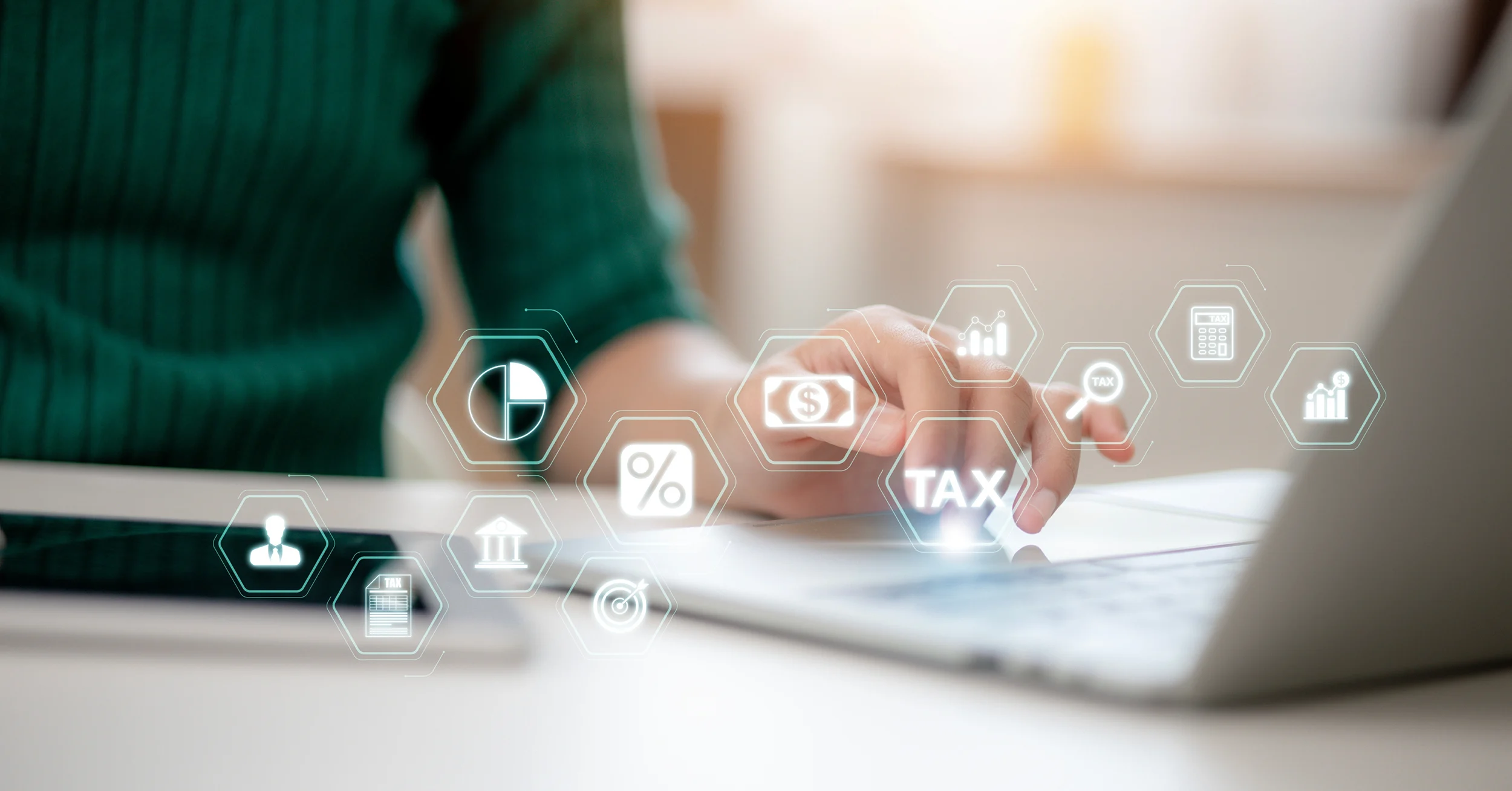 Person using a laptop with digital tax and finance icons overlayed, representing Payroll Automation Tax Compliance in Pakistan for efficient business operations.